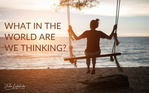 What in the world are we thinking? woman thinking on swing, looking off into the water