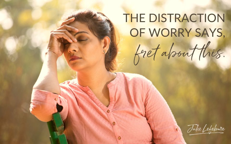 The Distraction of Worry says "Fret About This" | woman sitting on bench with head in hand