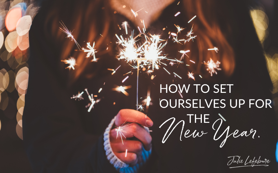 How to Set Ourselves Up for the New Year | woman with coat on holding a sparkler