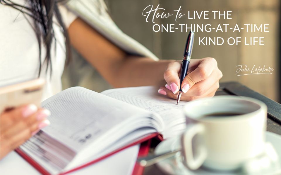 How to the One Thing at a Time Kind of Life | woman writing in a book with a cup of coffee beside her