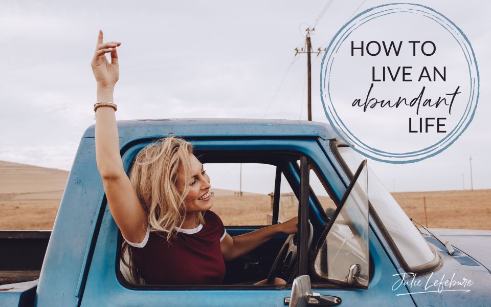 How to Life an Abundant Life | woman driving old blue truck with head and arm raised out window