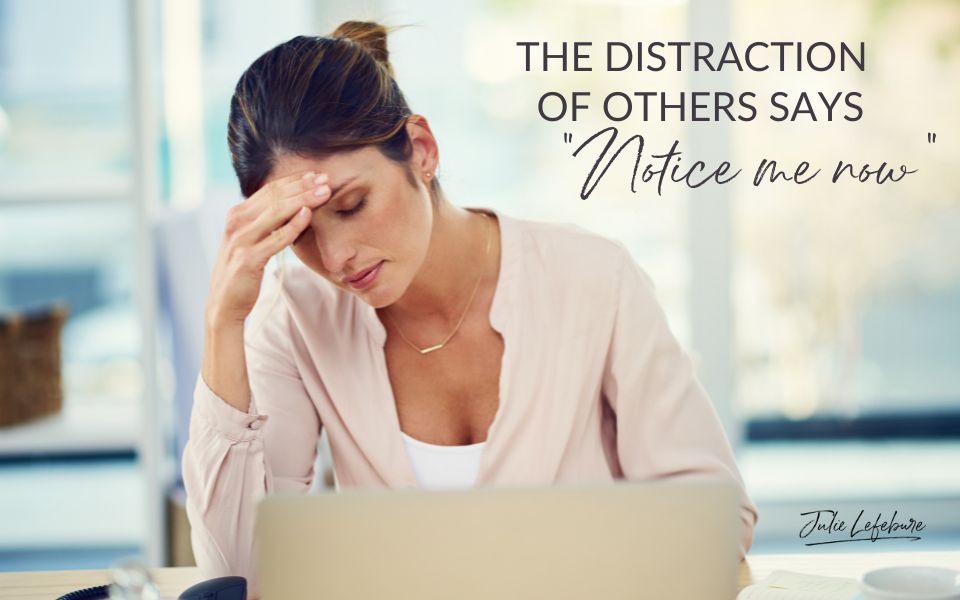 The Distraction of Others Says, "Notice Me Now" | woman sitting at computer with hand on forehead looking frustrated