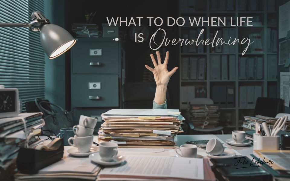 What to Do When Life Is Overwhelming | woman's hand extended above a cluttered desk