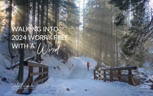 Walking Into 2024 Worry Free With a Word | woman walking on a snow-covered path through trees with sunbeams streaming through