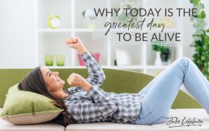 Why Today Is the Greatest Day to Be Alive | woman in plaid shirt and jeans lying on a green couch with victory punches in the air