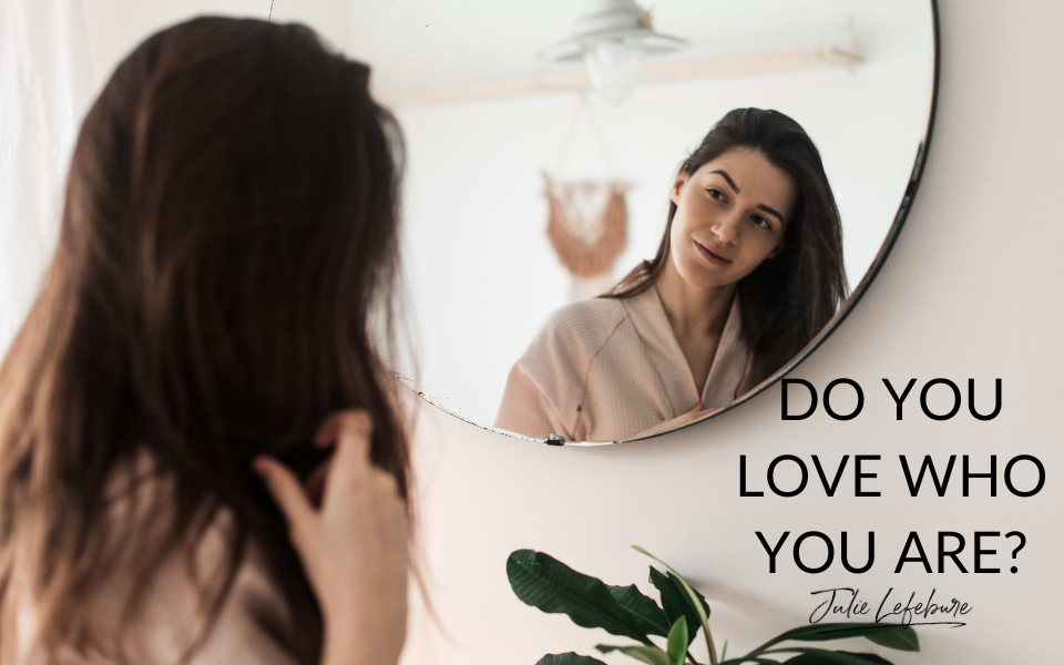 Do You Love Who You Are? | woman with long dark hair looking at herself in mirror