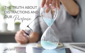 The Truth About Distractions and Our Purpose | woman sitting at a table with eye glasses in one hand and an hour glass in the other